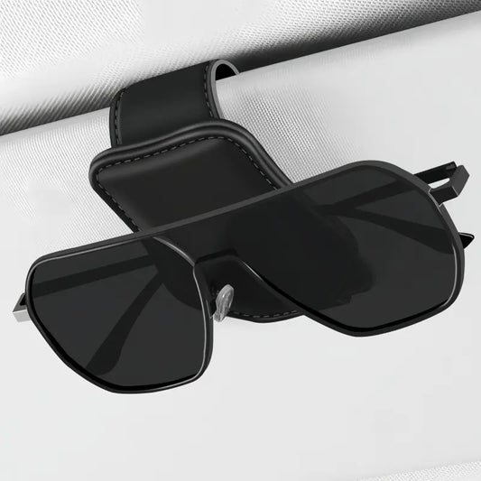 Magnetic sunglasses holder clipped to a car sun visor