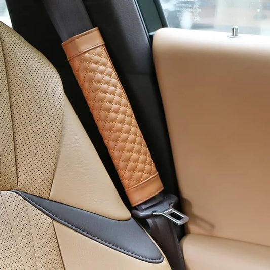 Soft leather plaid car seat belt cover pad on a shoulder strap