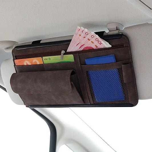 Suede sun visor organizer with card and glasses pockets mounted on a car visor